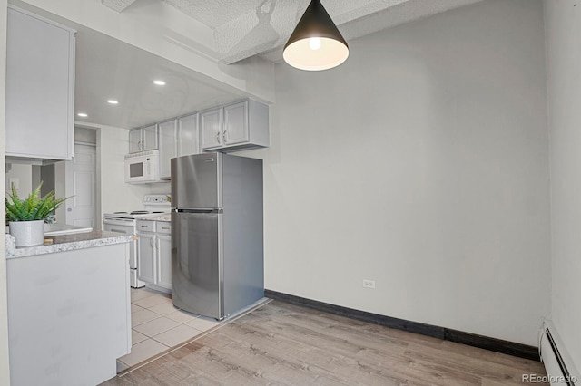 kitchen featuring white appliances, light wood finished floors, a baseboard radiator, baseboards, and light countertops