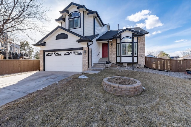 view of front of house featuring entry steps, a garage, concrete driveway, fence, and brick siding