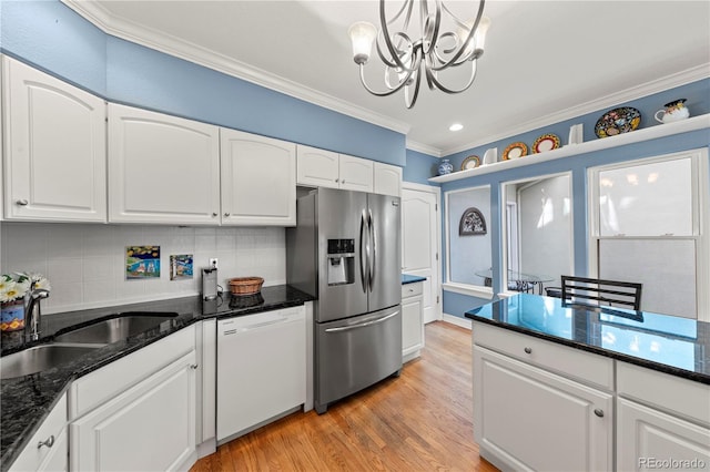 kitchen featuring light wood finished floors, dishwasher, ornamental molding, stainless steel refrigerator with ice dispenser, and a sink