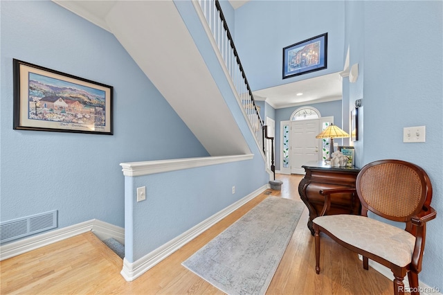 interior space featuring stairs, wood finished floors, visible vents, and baseboards