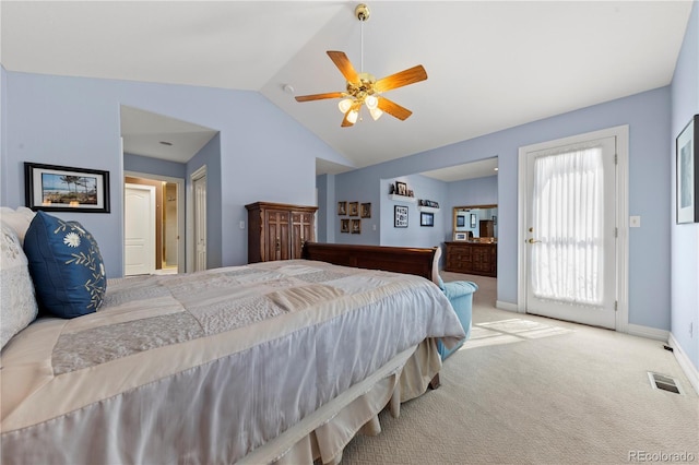 carpeted bedroom with visible vents, a ceiling fan, baseboards, and vaulted ceiling