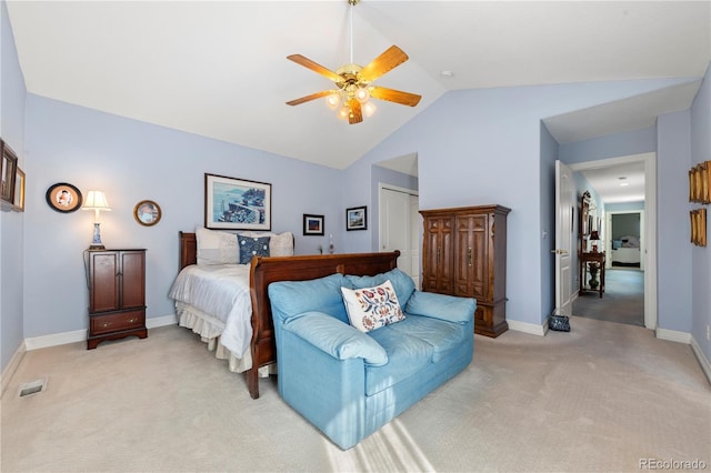 bedroom featuring a closet, light colored carpet, baseboards, and lofted ceiling