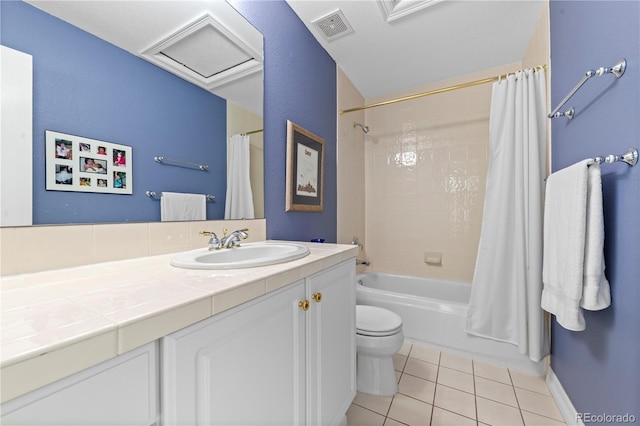 bathroom featuring vanity, visible vents, tile patterned flooring, shower / bath combo with shower curtain, and toilet