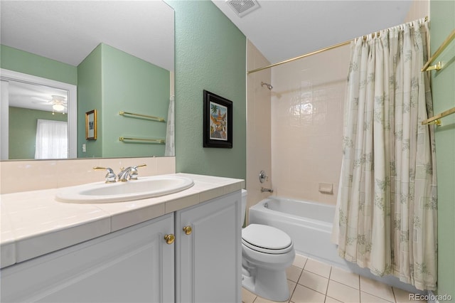 full bathroom featuring tile patterned floors, visible vents, shower / tub combo with curtain, toilet, and vanity