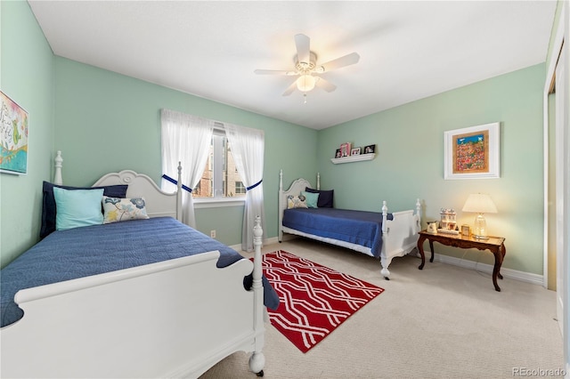 bedroom with carpet flooring, a ceiling fan, and baseboards