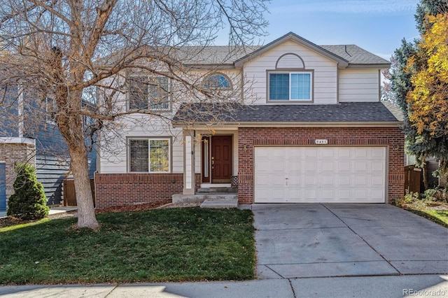 view of front property featuring a garage and a front lawn