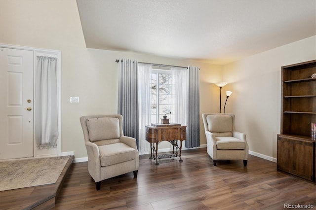 living area with dark wood-type flooring and a textured ceiling