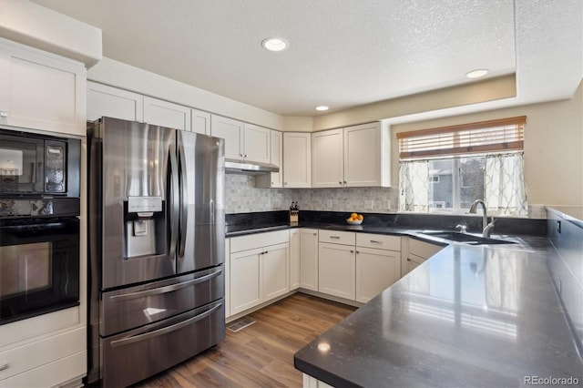 kitchen with sink, white cabinets, dark hardwood / wood-style flooring, and black appliances