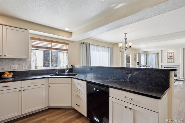 kitchen with sink, white cabinetry, black dishwasher, dark hardwood / wood-style flooring, and decorative backsplash