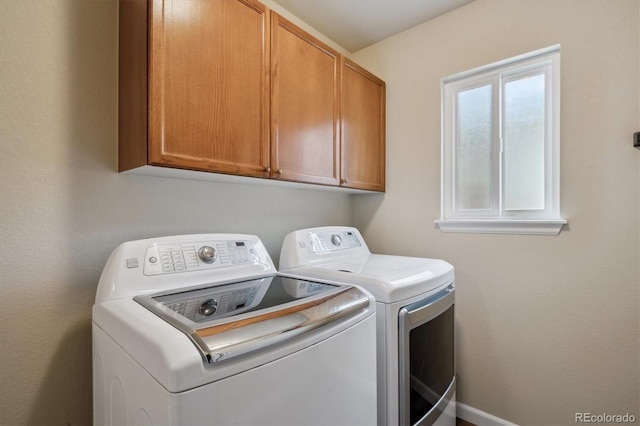 laundry area with cabinets and washing machine and dryer