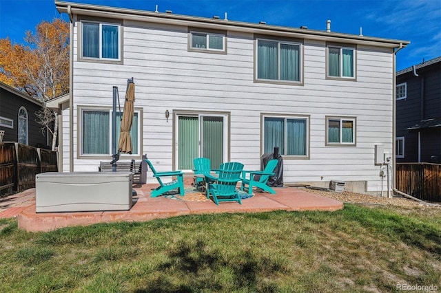 back of property featuring a lawn and a patio