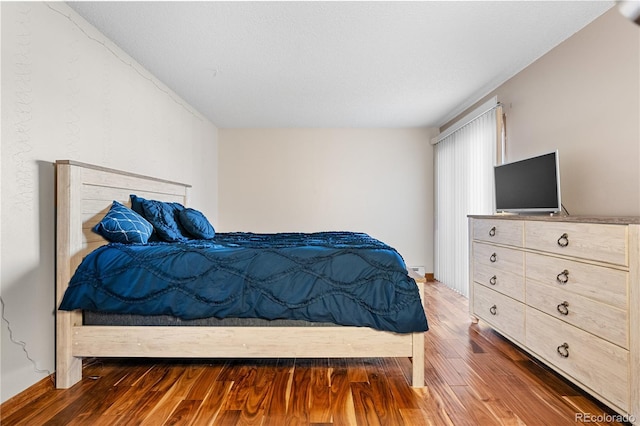 bedroom with hardwood / wood-style flooring