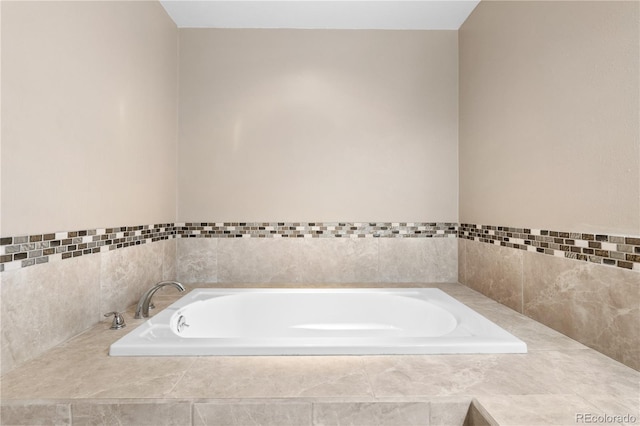 bathroom with tiled tub