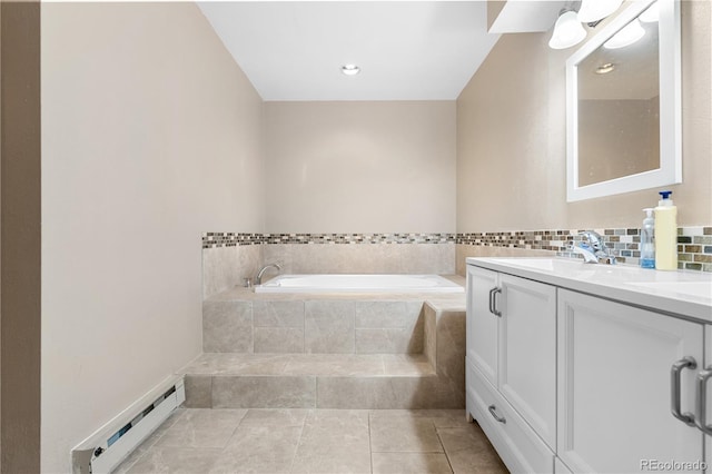 bathroom featuring vanity, backsplash, tile patterned flooring, baseboard heating, and tiled tub