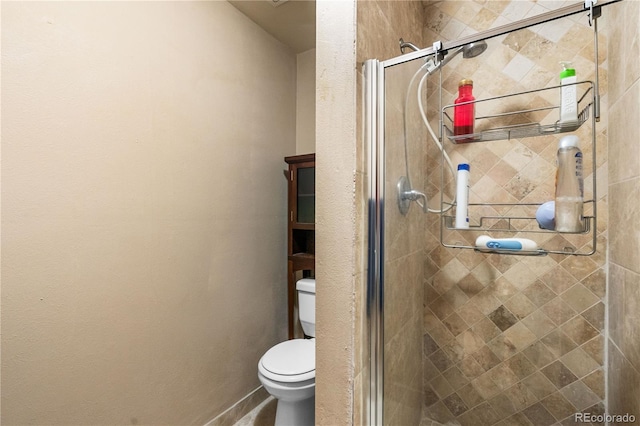 bathroom with an enclosed shower and toilet