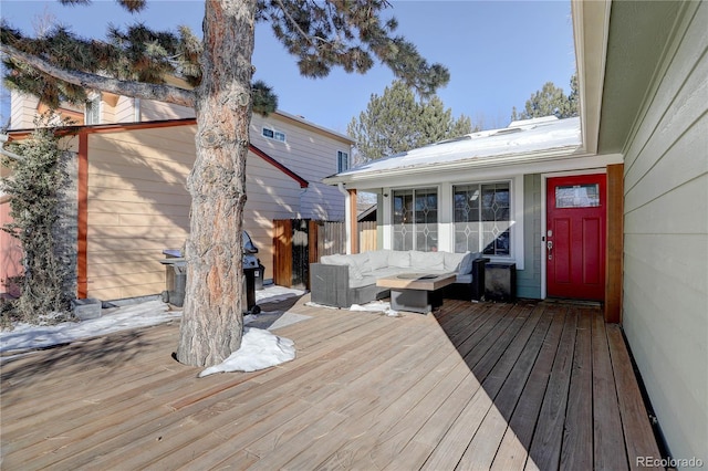 wooden deck with a grill and an outdoor hangout area