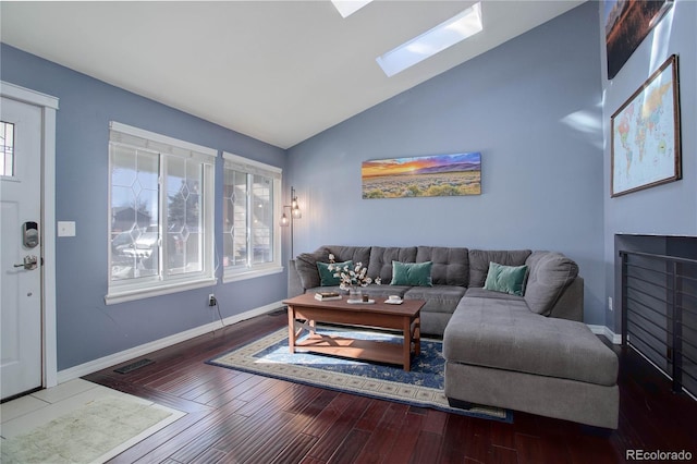 living room with hardwood / wood-style flooring and lofted ceiling with skylight