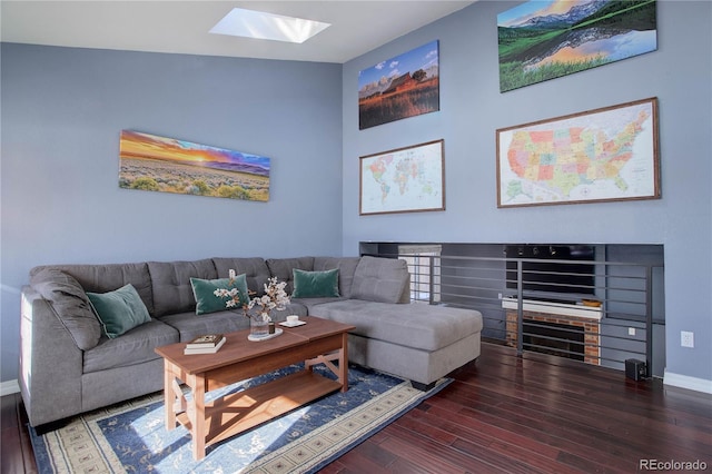 living room featuring dark hardwood / wood-style floors and a skylight