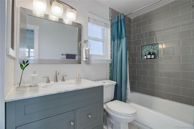 full bathroom with vanity, shower / bath combination with curtain, and toilet