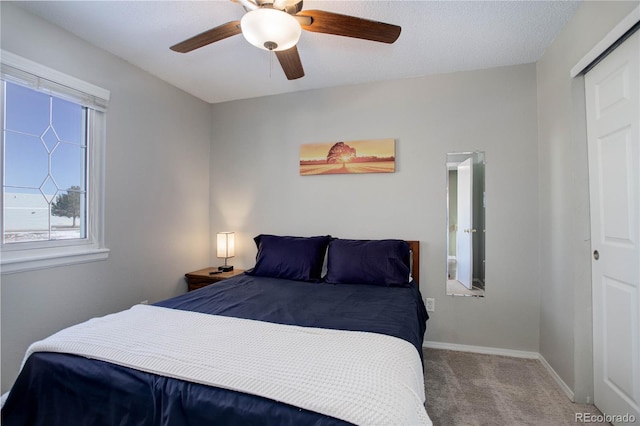 carpeted bedroom with ceiling fan and a closet