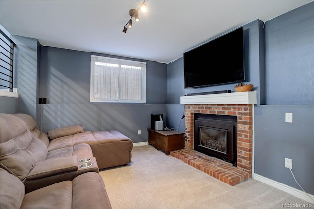 carpeted living room with rail lighting and a brick fireplace