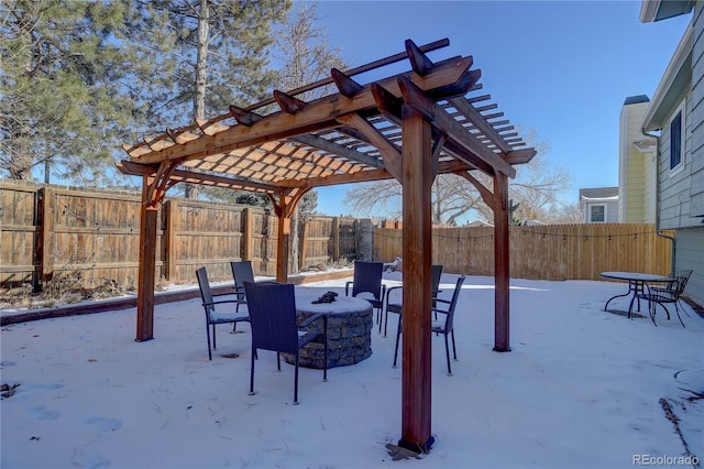 snow covered patio with a pergola