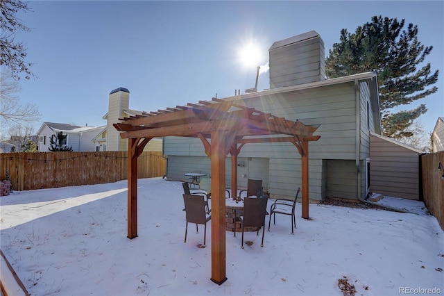 snow covered property featuring a pergola