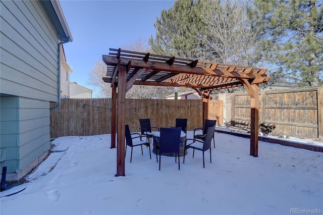 snow covered patio featuring a pergola