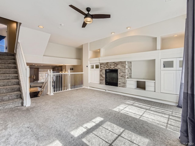 unfurnished living room with carpet and ceiling fan