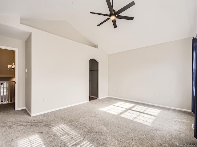 carpeted empty room with high vaulted ceiling and ceiling fan