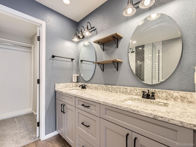 bathroom featuring vanity, hardwood / wood-style floors, and walk in shower