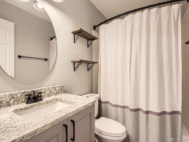 bathroom featuring vanity, toilet, and a shower with shower curtain