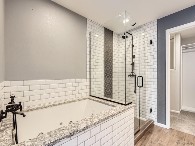 bathroom featuring independent shower and bath and hardwood / wood-style flooring