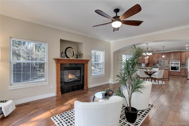 living room featuring visible vents, crown molding, and light wood finished floors