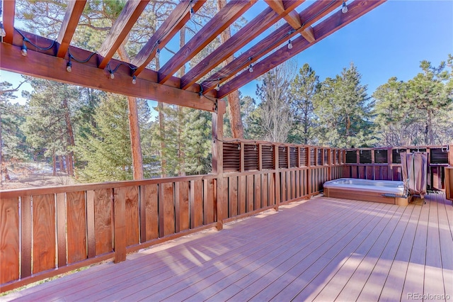 wooden terrace with hot tub deck surround and a pergola