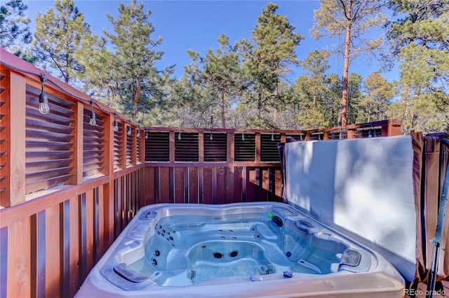 wooden deck with a hot tub