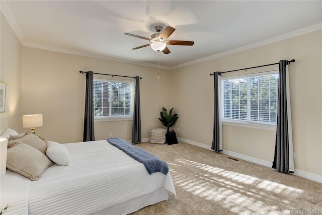 bedroom with ornamental molding, carpet, baseboards, and a ceiling fan