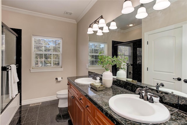 bathroom featuring crown molding, a sink, and baseboards