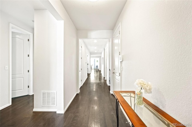 corridor featuring dark hardwood / wood-style floors