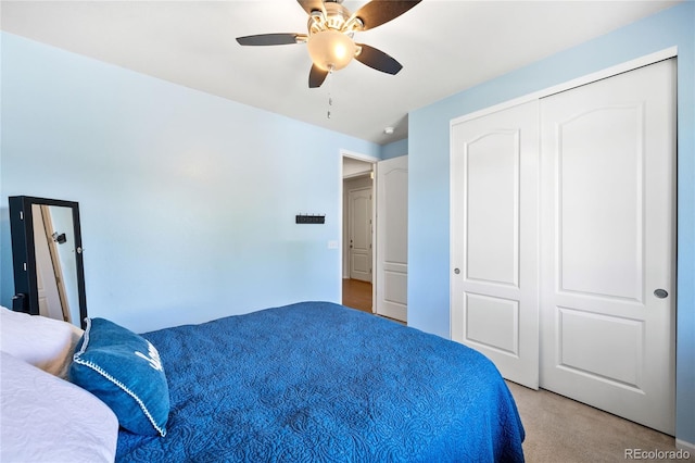 bedroom featuring ceiling fan, a closet, and light carpet