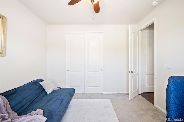 sitting room with light colored carpet and ceiling fan