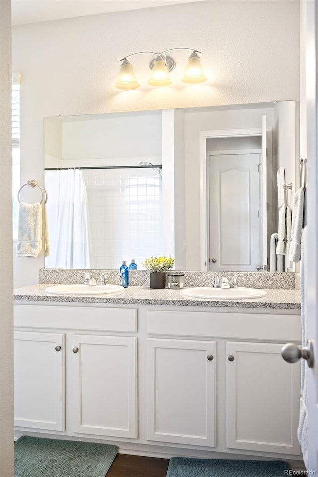 bathroom with a shower with shower curtain and vanity