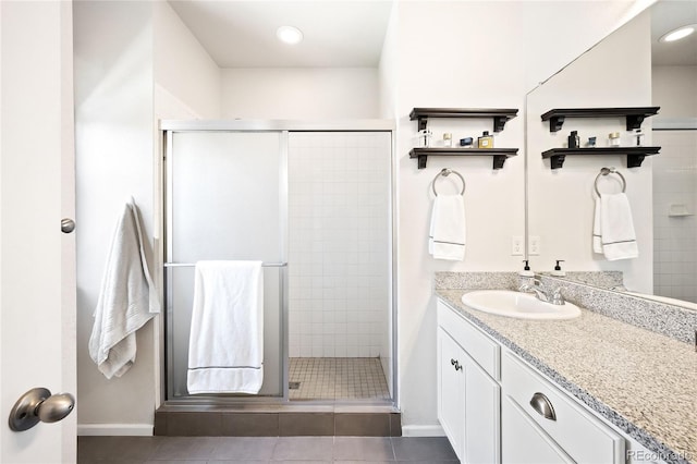 bathroom featuring vanity, tile patterned floors, and walk in shower