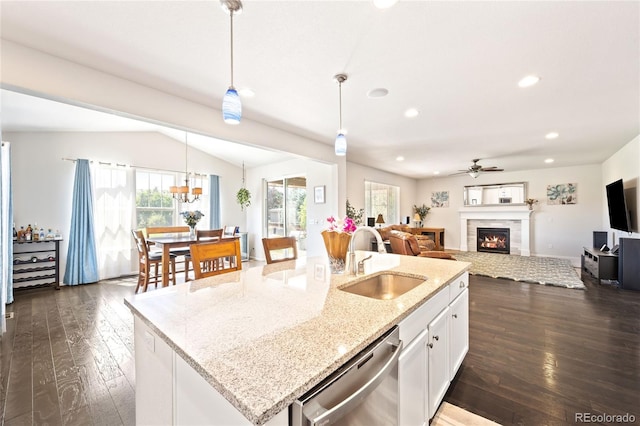 kitchen featuring dark hardwood / wood-style flooring, sink, an island with sink, pendant lighting, and stainless steel dishwasher