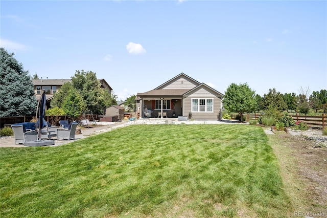 back of house with a patio area and a lawn