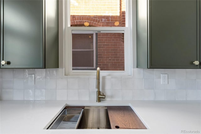 kitchen featuring sink, decorative backsplash, and green cabinets