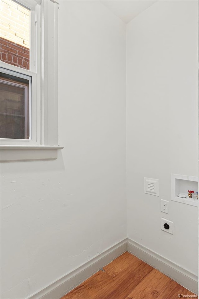 laundry area with hookup for a washing machine, hookup for an electric dryer, and hardwood / wood-style floors