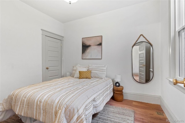 bedroom with hardwood / wood-style floors