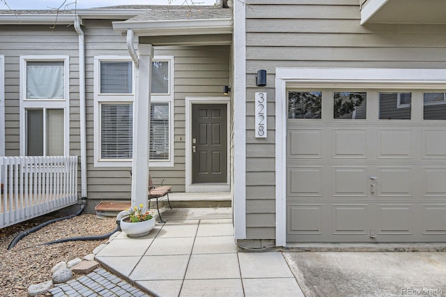 3228 47th, Boulder, CO 80301 - view of exterior entry featuring a garage and a shingled roof