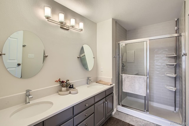 3228 47th, Boulder, CO 80301 - bathroom featuring double vanity, a shower stall, tile patterned floors, and a textured ceiling